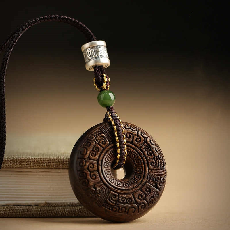 Close-up of agarwood pendant necklace showing intricate craftsmanship