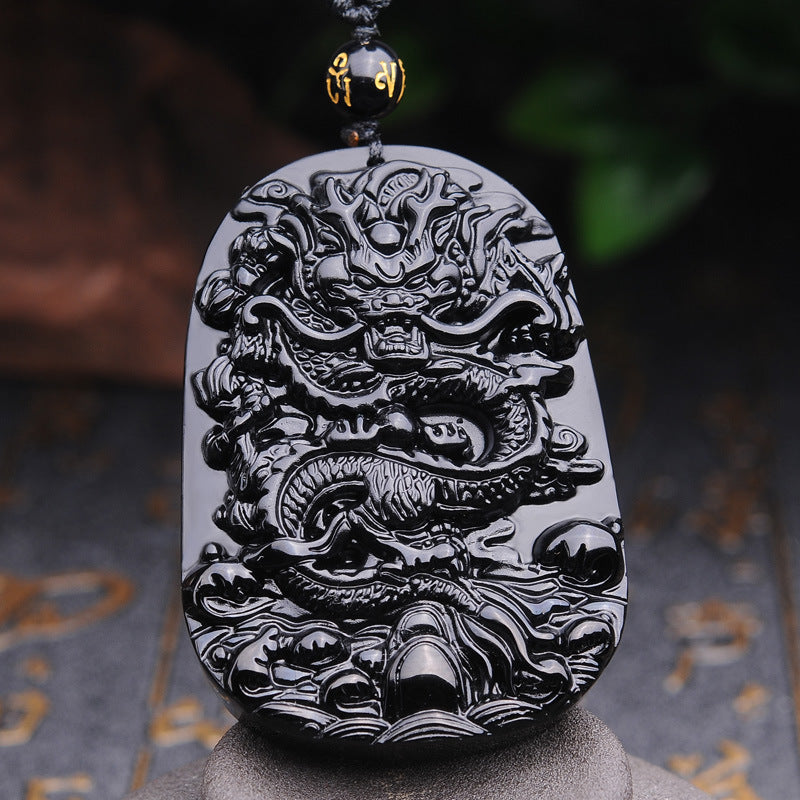 Front view of Black Obsidian Dragon Pendant Necklace, highlighting the intricate dragon emblem