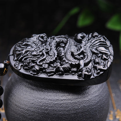 Side view of Black Obsidian Dragon Pendant, showing the craftsmanship of the Chinese dragon design