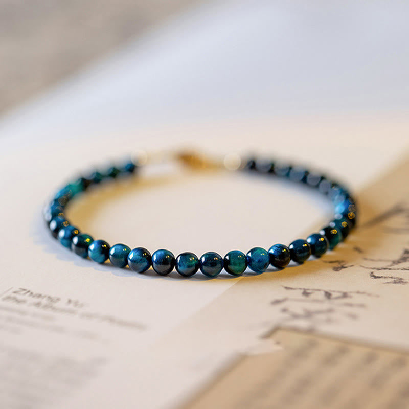 lose-up view of the texture and shine of the blue tiger eye beads on the bracelet