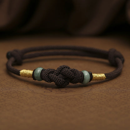 brown string bracelet with jade