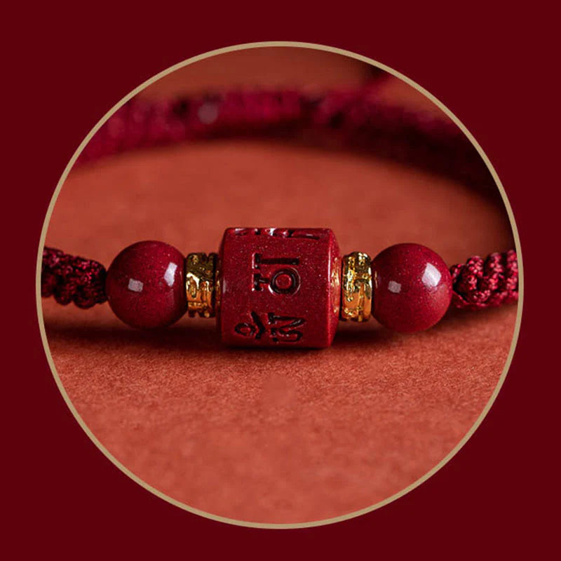 Close-up of cinnabar accessory on Tibetan Red String Bracelet, featuring Six True Words engraving