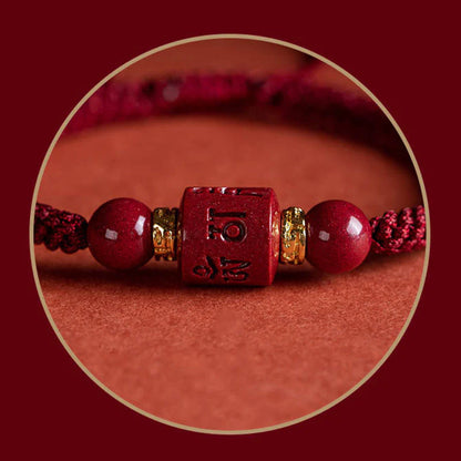 Close-up of cinnabar accessory on Tibetan Red String Bracelet, featuring Six True Words engraving