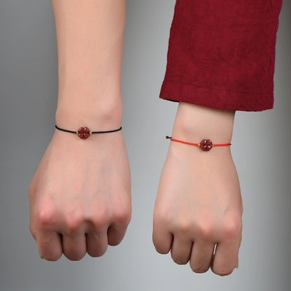 Couple wearing the Natural Cinnabar Four Leaf Clover Blessing Red String Bracelets