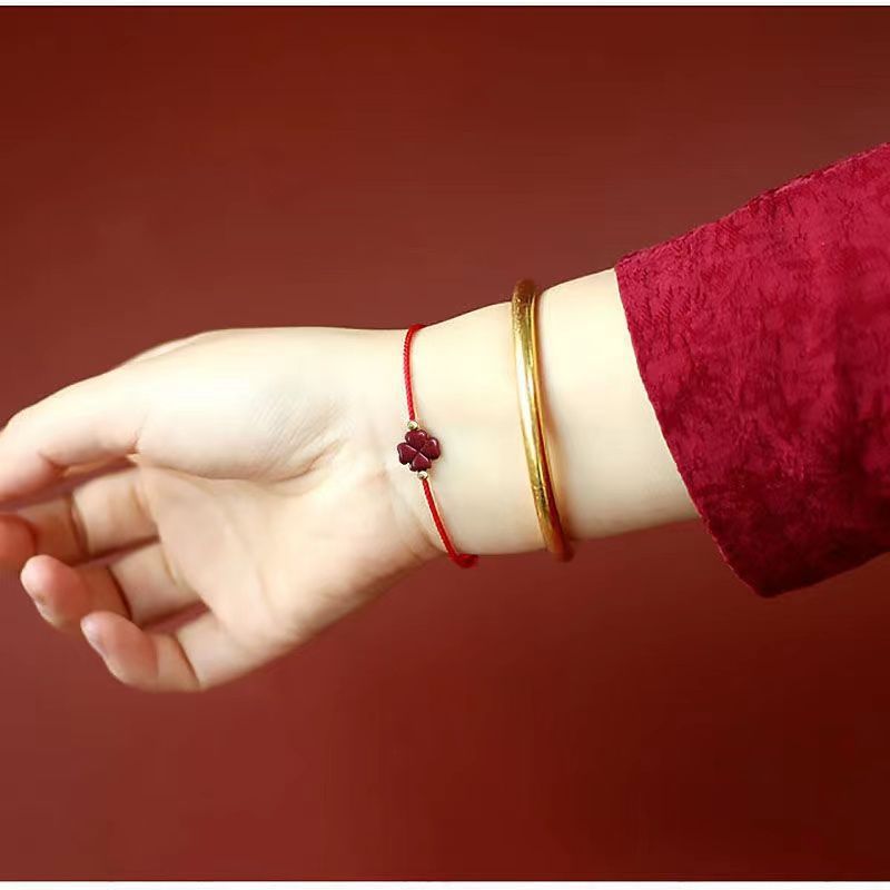 Deep red Cinnabar Four Leaf Clover Bracelet worn on wrist