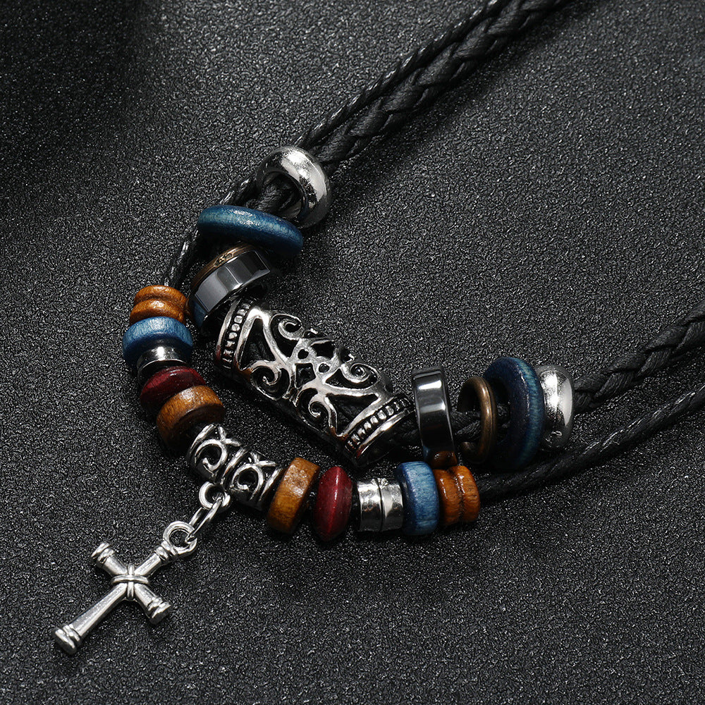 Detailed view of the alloy cross pendant and wooden beads on the Double Cross Wood Bead Necklace