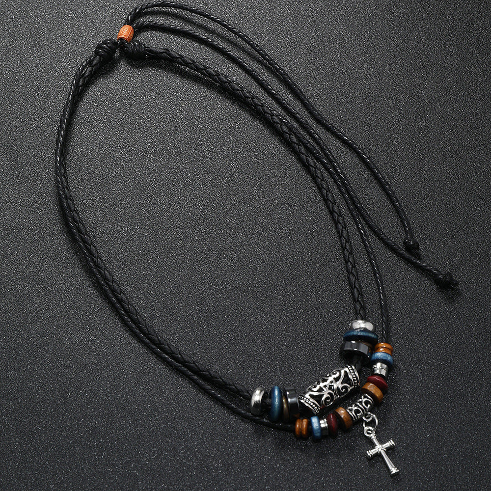 Flat lay of Double Cross Wood Bead Necklace showing alloy cross pendant and wooden beads arranged neatly