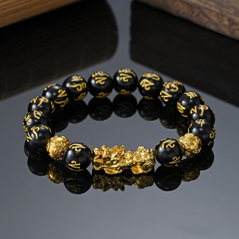 Close-up of Feng Shui Pi Xiu Obsidian Bracelet for wealth with gold-plated Pi Xiu charm