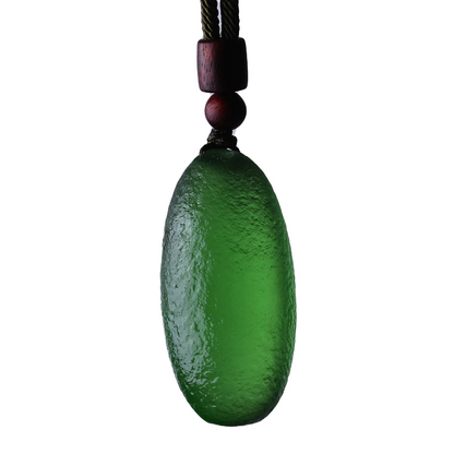 Green meteorite pendant necklace on a white background, showcasing the unique cosmic design and protection qualities