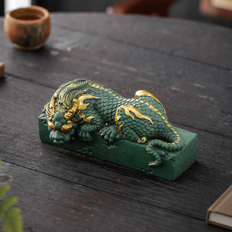 Hand-carved Qing Sha Stone lying dragon statue, symbolizing tranquility and strength.