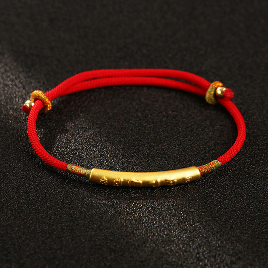 Close-up of Tibetan Lucky Charm Red String Bracelet with gold charm