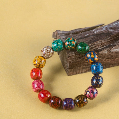 Side view of lacquer bead bracelet with intricate designs