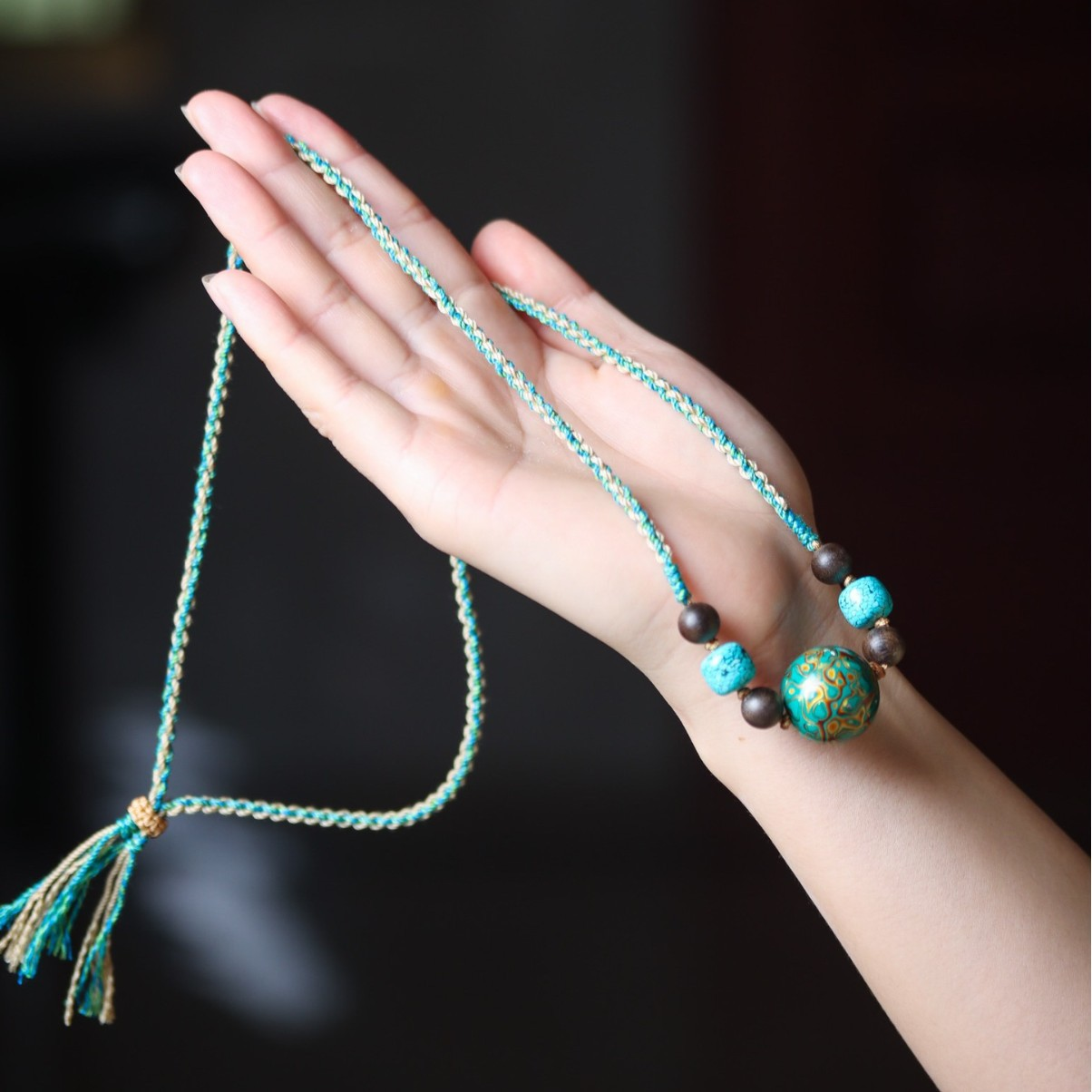 Serenity Necklace with Turquoise and Lacquer Bead displayed on hand for a detailed view