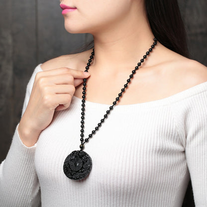 Obsidian pendant necklace worn by female model