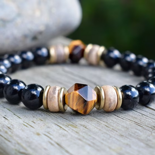 Close-up of the tiger eye beads on the Obsidian Bead Bracelet, showcasing the unique facets