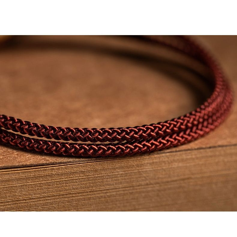 Detail view of red string bracelet with fine craftsmanship