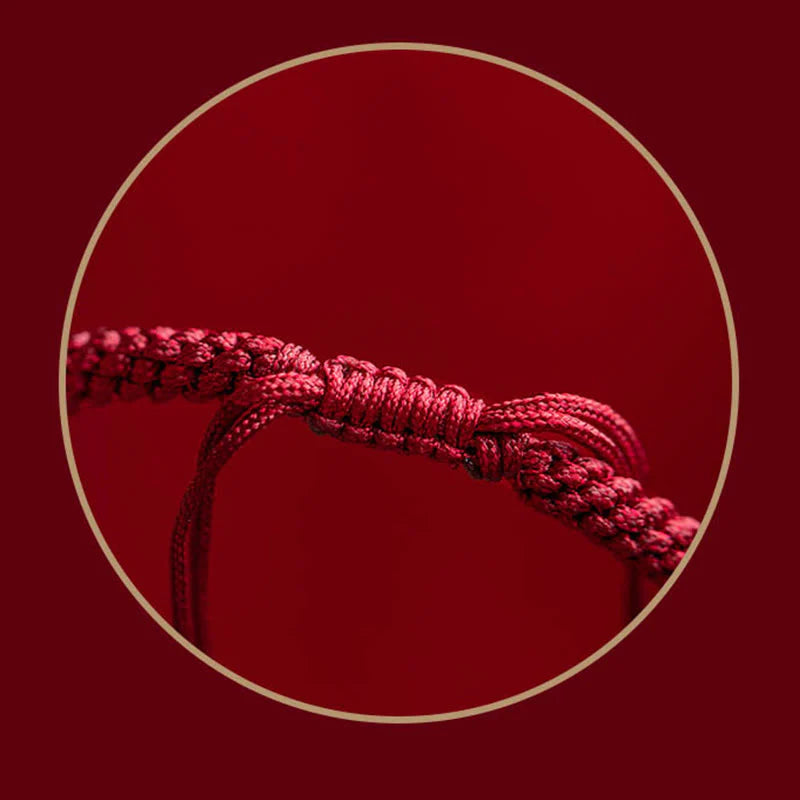 Detailed view of red string on Tibetan Cinnabar Bracelet, symbolizing good fortune and protection