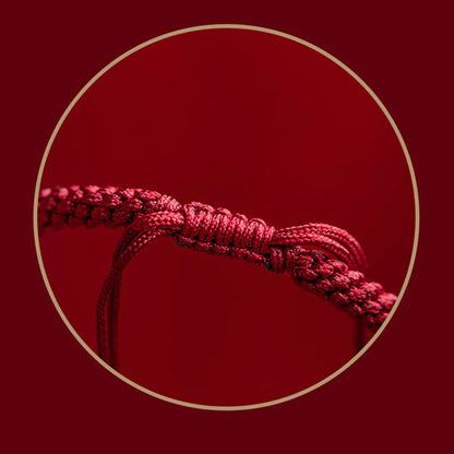 Detailed view of red string on Tibetan Cinnabar Bracelet, symbolizing good fortune and protection