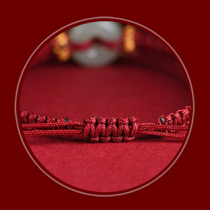 Close-up of the red string and peace buckle on the Hetian jade protection bracelet