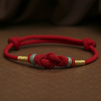 red string barcelet with jade