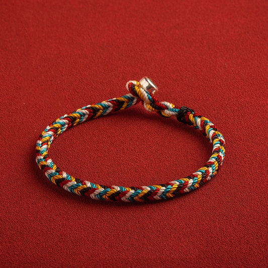 Tibet Handmade Protection Braid Bracelet on red background, showcasing spiritual protection and craftsmanship