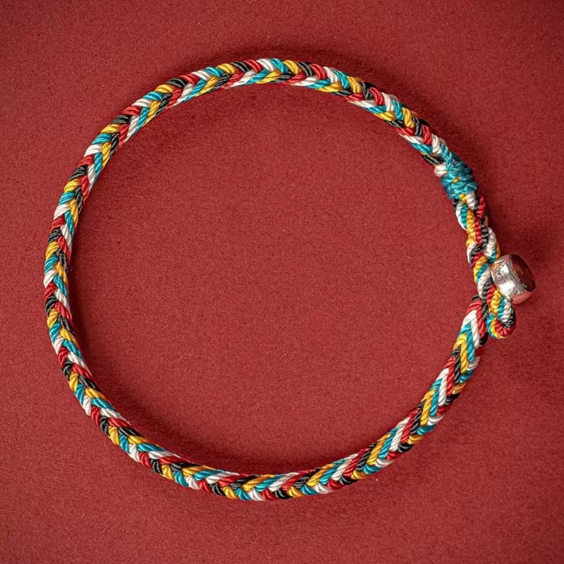 Tibet Handmade Protection Braid Bracelet, braided design shown on red background for visual impact