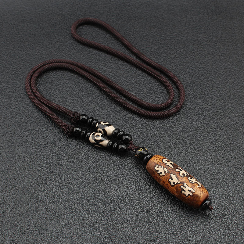 Tibetan Dzi Stone Beads Necklace displayed flat on a surface