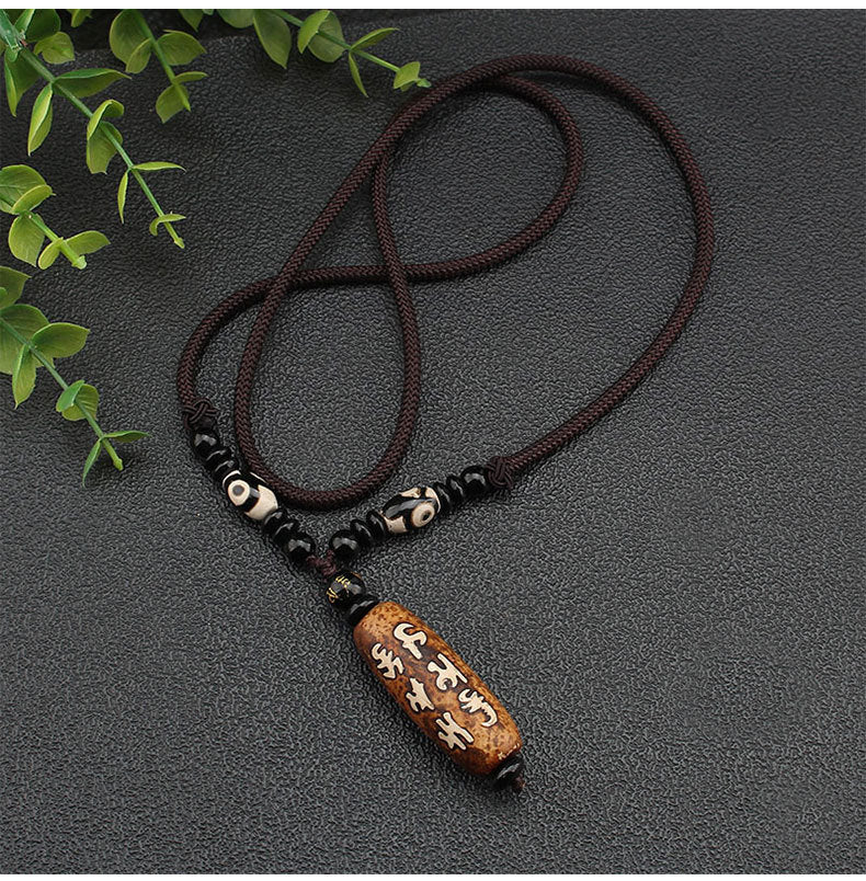 Close-up of Tibetan Dzi Stone Beads Necklace on flat surface