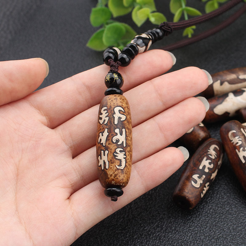 Tibetan Dzi Stone Beads Necklace held in hand to show scale