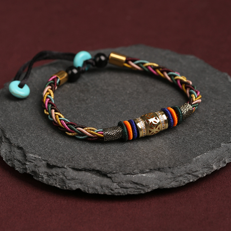 Side view of Tibetan King Kong Knot Luck Weave String Bracelet on a display stand