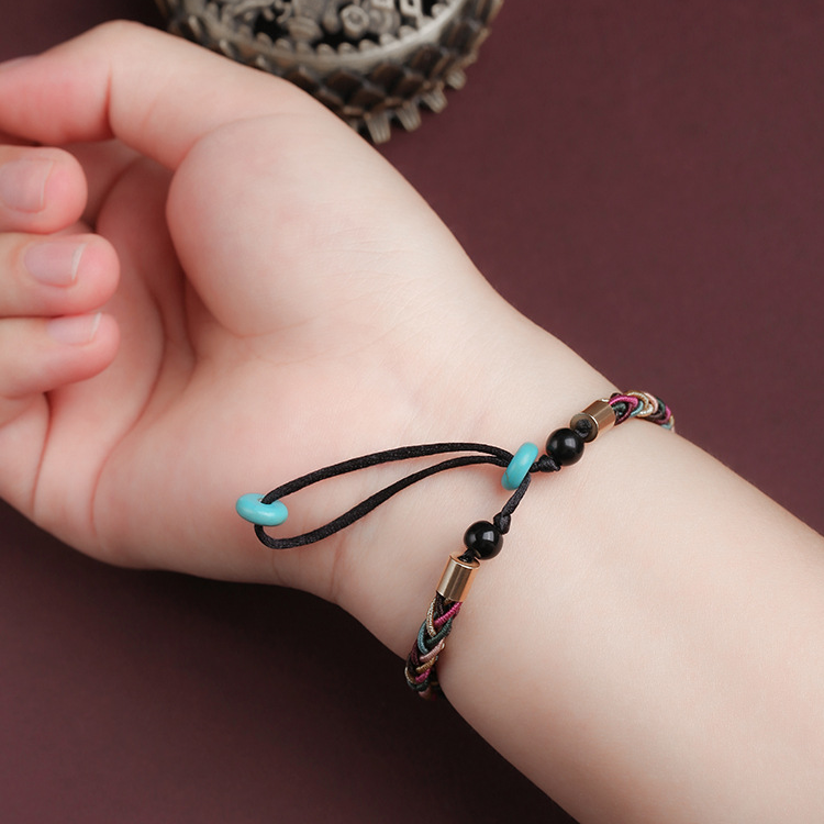 Tibetan bracelet worn on wrist, symbolizing spiritual protection and good fortune