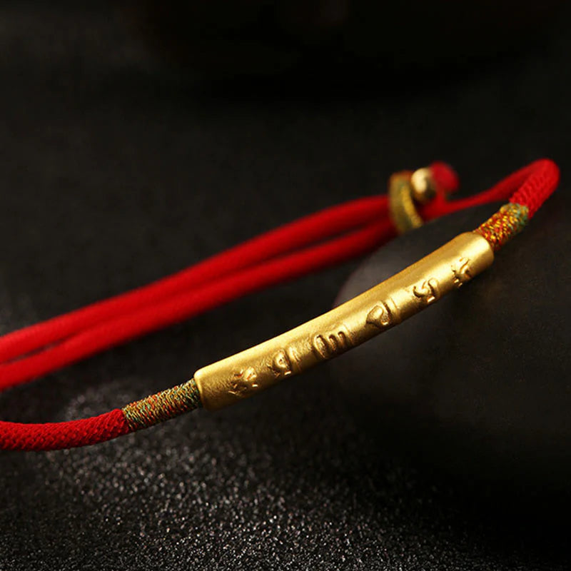 Close-up of Tibetan Lucky Charm Red String Bracelet with gold charm