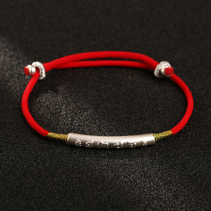 Close-up of Tibetan Lucky Charm Red String Bracelet with silver charm