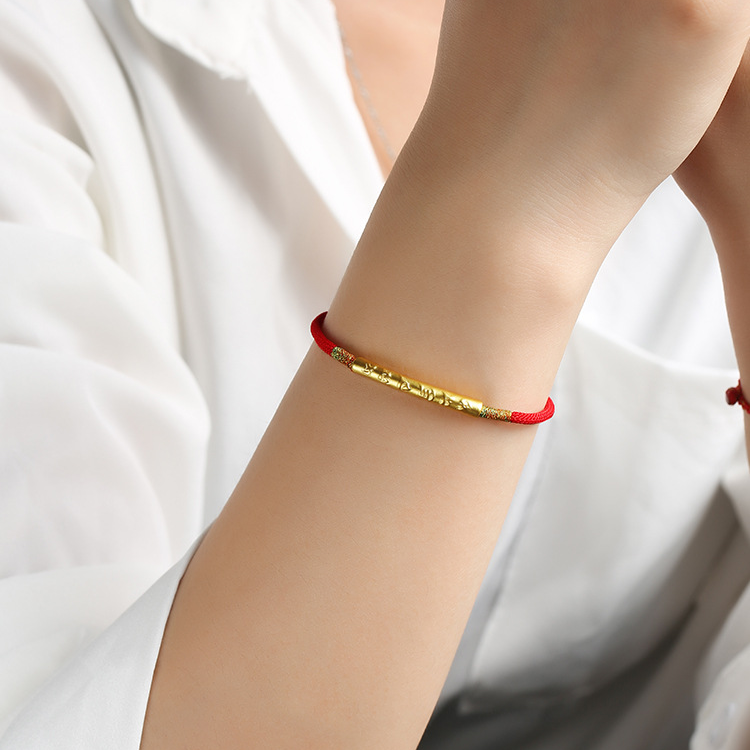 Tibetan Lucky Charm Red String Bracelet with gold charm worn on wrist