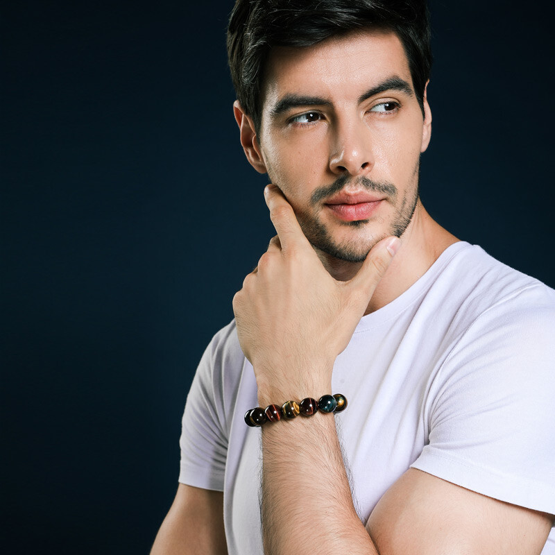 Man wearing the Natural Tiger Eye Positive Protection Bracelet, demonstrating the bracelet's fit and design