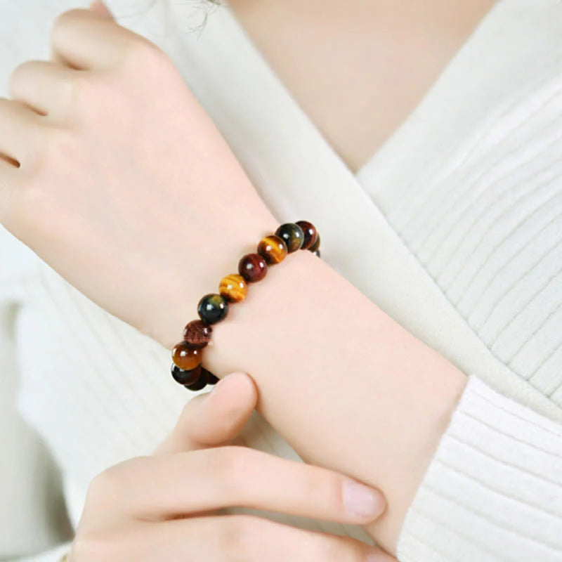 Close-up of a woman wearing the Natural Tiger Eye Positive Protection Bracelet, focusing on the protection energy it provides