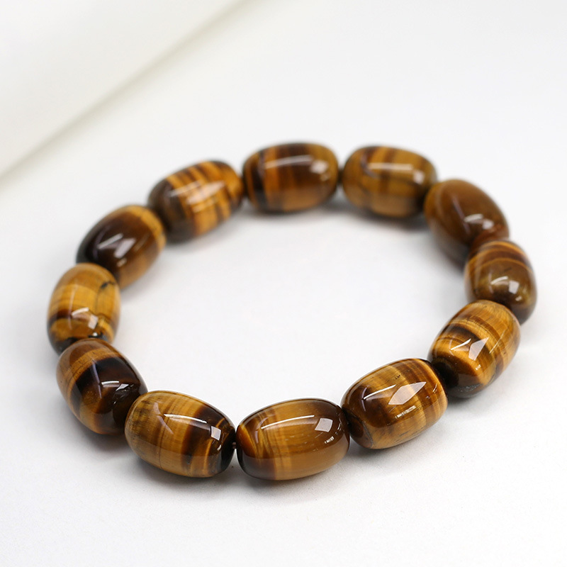 Close-up view of the Natural Tiger's Eye Wisdom Bracelet with barrel beads on white background