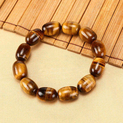 Natural Tiger's Eye Wisdom Bracelet with barrel beads, displayed on elegant textured background