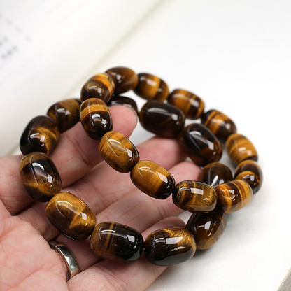 Natural Tiger's Eye Wisdom Bracelet worn on hand, showcasing the fit and design of the barrel beads