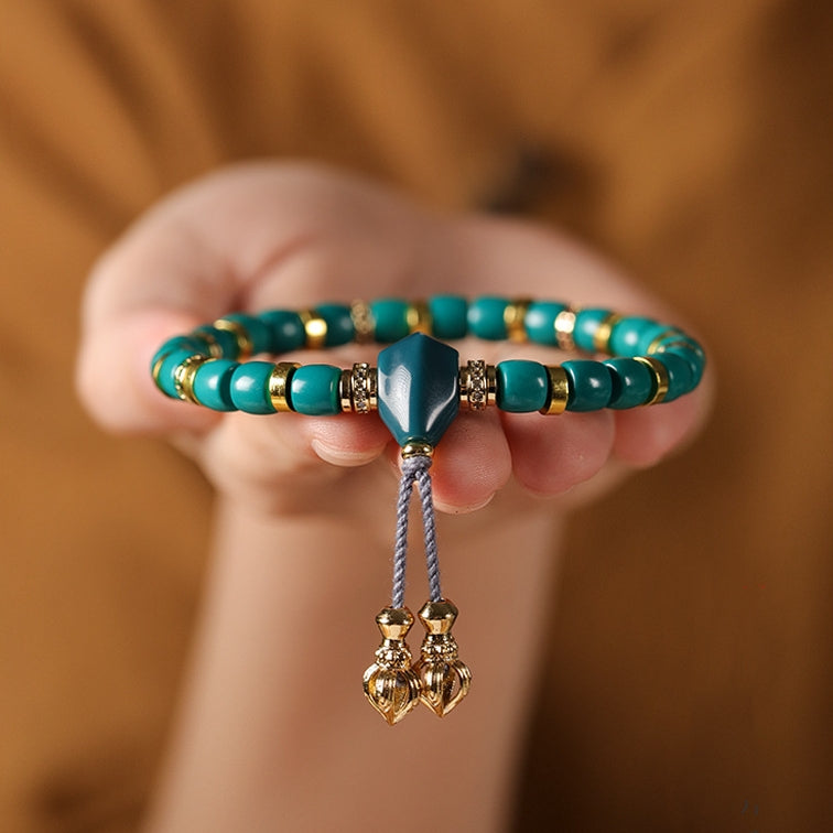 Close-up of the Turquoise Lucky Bracelet on the model's hand, highlighting its protective energy