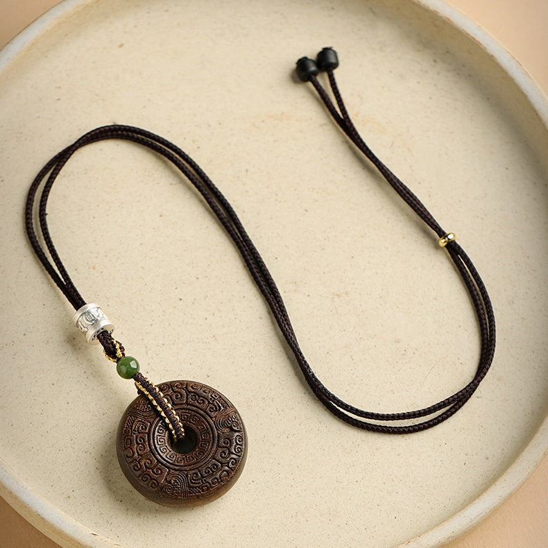 Full view of wooden necklace with agarwood pendant and Hetian jade detail